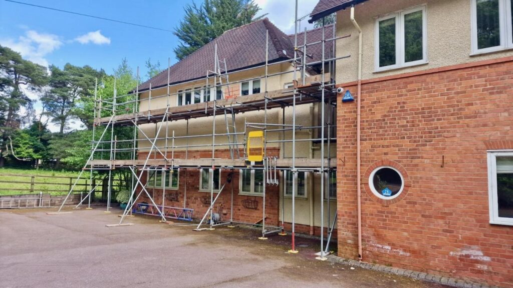 Scaffold providing safe roof access during a summer roofing project in the Birmingham