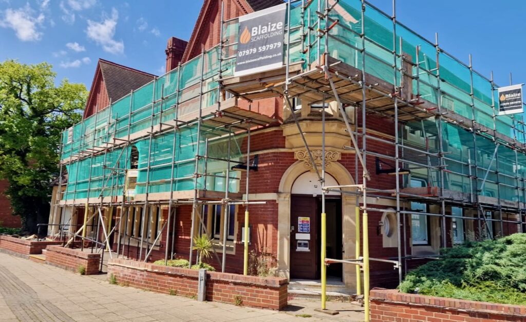 Commercial scaffolding with stair tower and hoarding on office building in the West Midlands